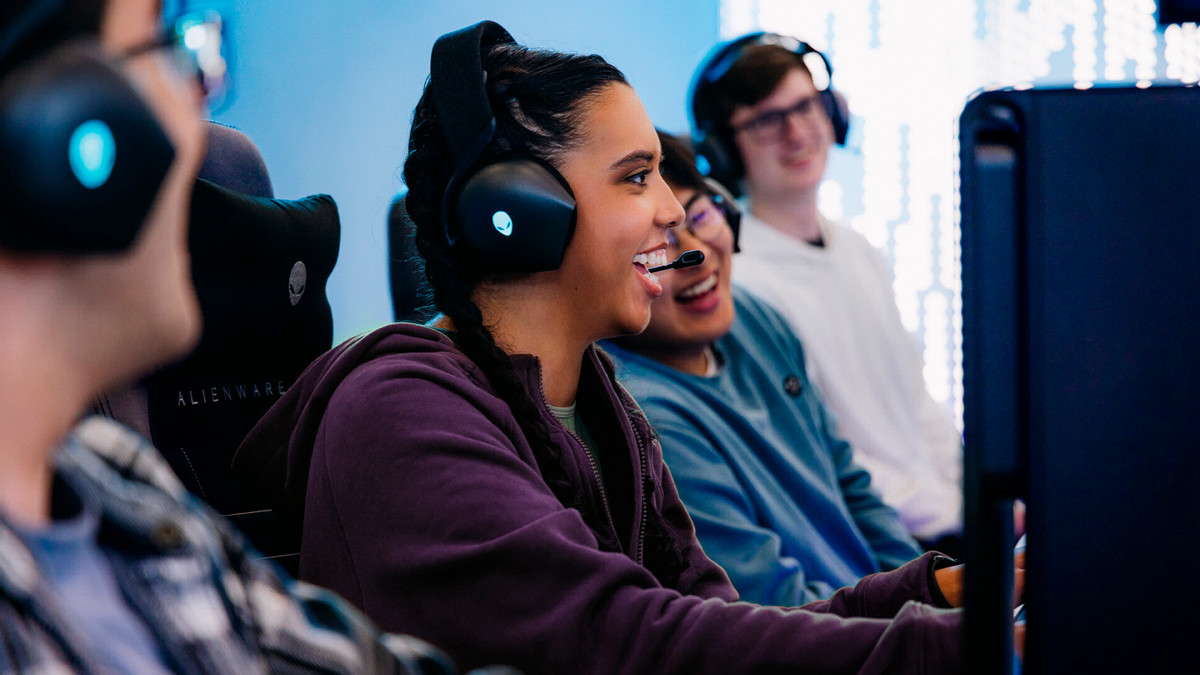 Students laughing, playing video games and enjoying the Alienware Purdue Gaming Lounge community. 